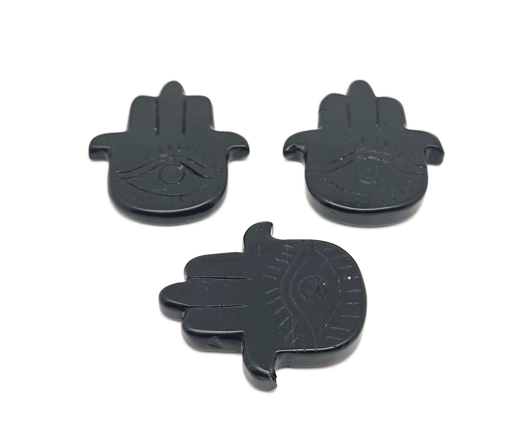 Obsidian Evil Eye hand gemstone carving with intricate details, designed for protection and spiritual significance by GemstoneGO.