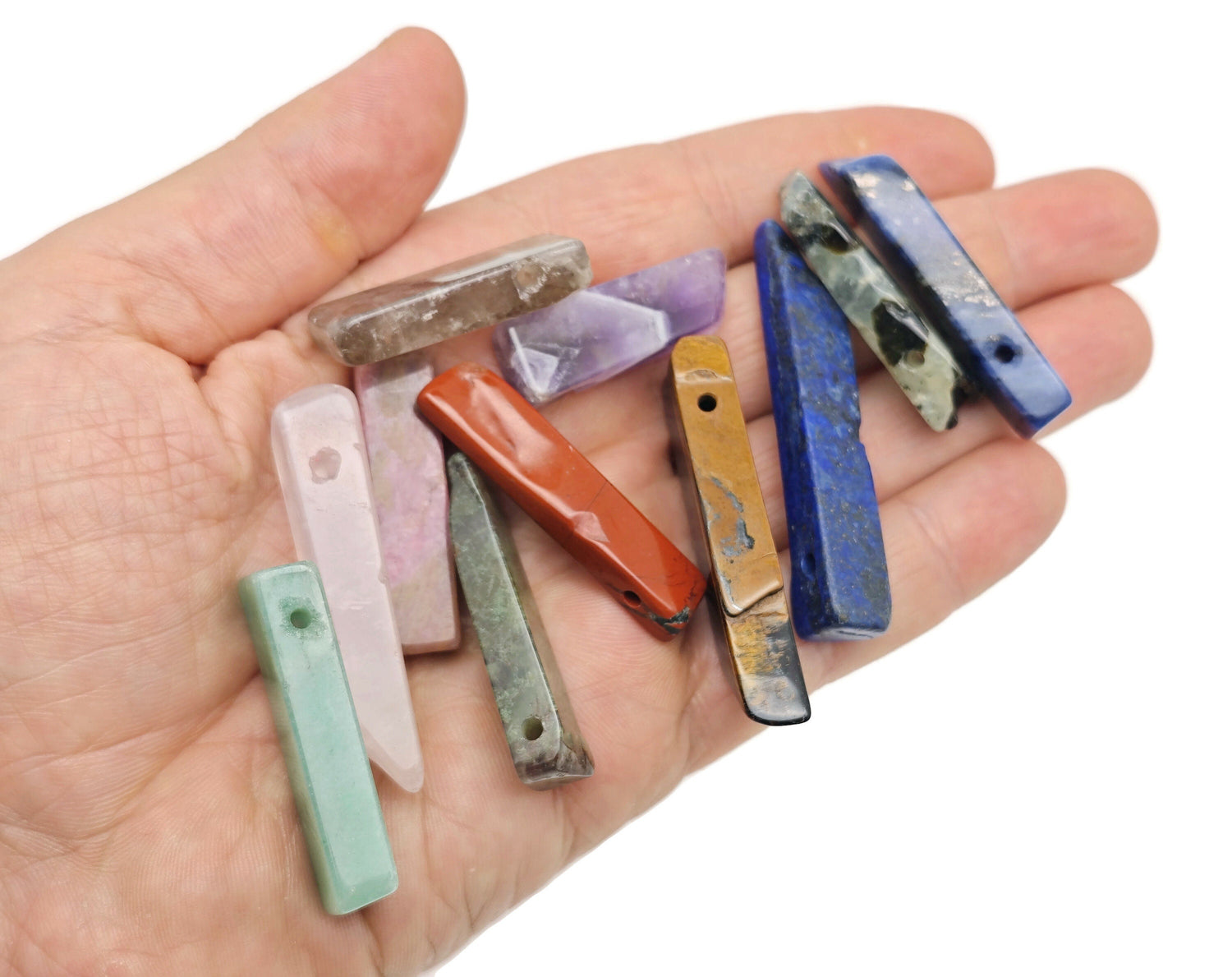 Drilled tumbled gemstone pendant with rectangular hole, showing colorful spiritual stones in a mix for jewelry making by GemstoneGO.