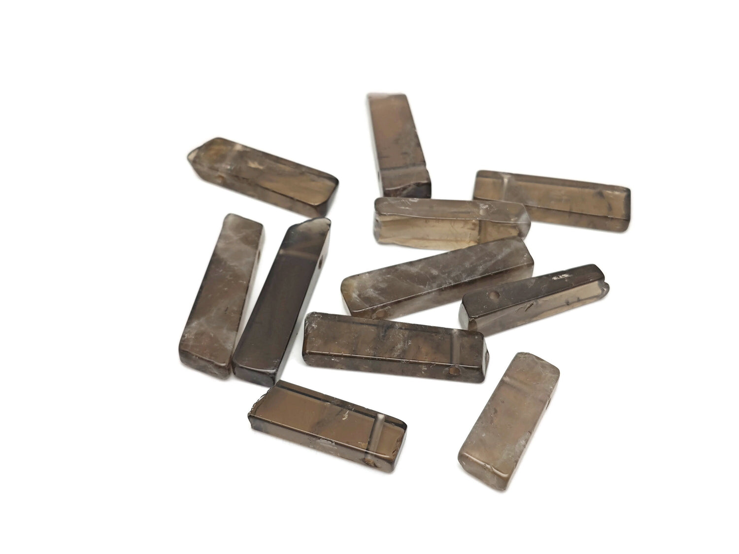 Smoky quartz drilled tumbled gemstone pendant from GemstoneGO showcasing a smooth, polished natural stone with a hole for jewelry.