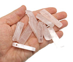 Rose quartz tumbled gemstone pendant with drilled hole, showcasing a smooth, pink, polished gemstone from GemstoneGO.