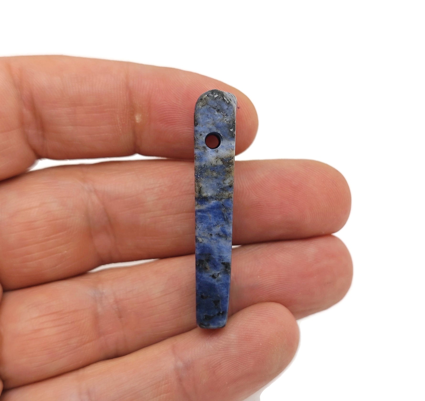 Sodalite drilled tumbled gemstone pendant from GemstoneGO with deep blue and white mineral patterns.