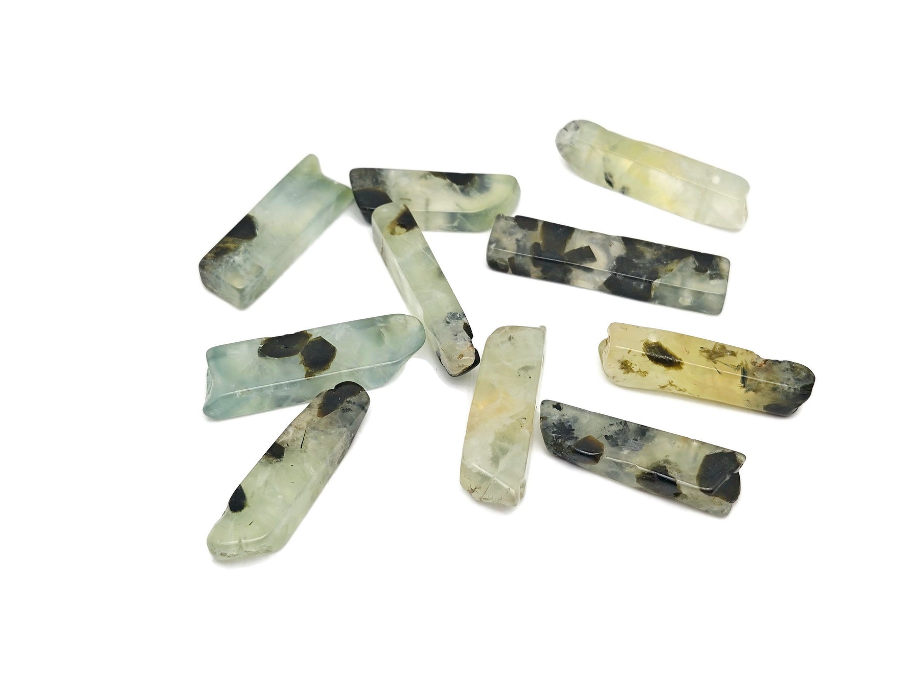 Prehnite drilled tumbled gemstone pendant from GemstoneGO with smooth, polished green stone and drilled hole for jewelry making.