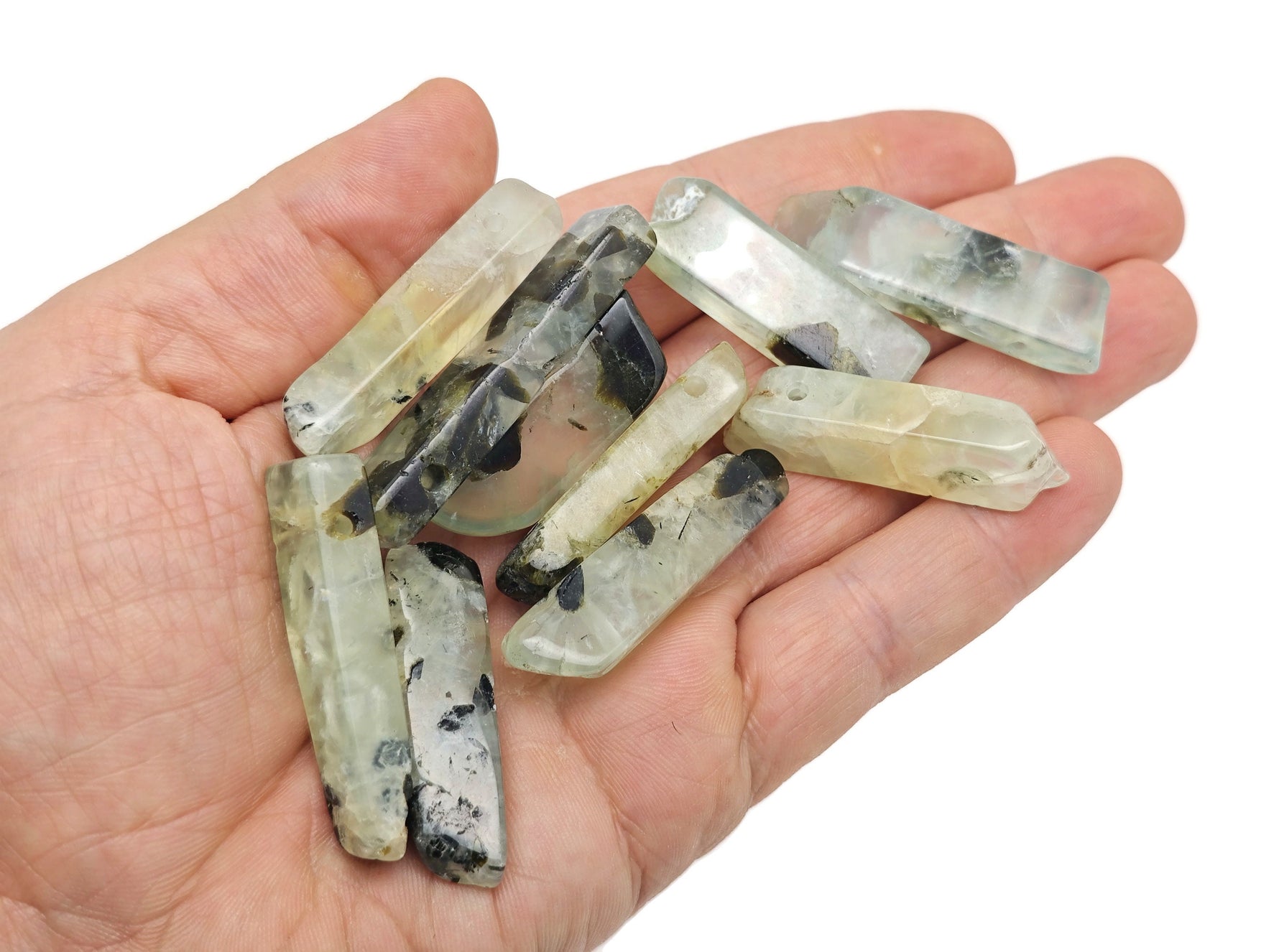Prehnite drilled tumbled gemstone pendant from GemstoneGO showing a smooth, polished green stone with a hole for jewelry.