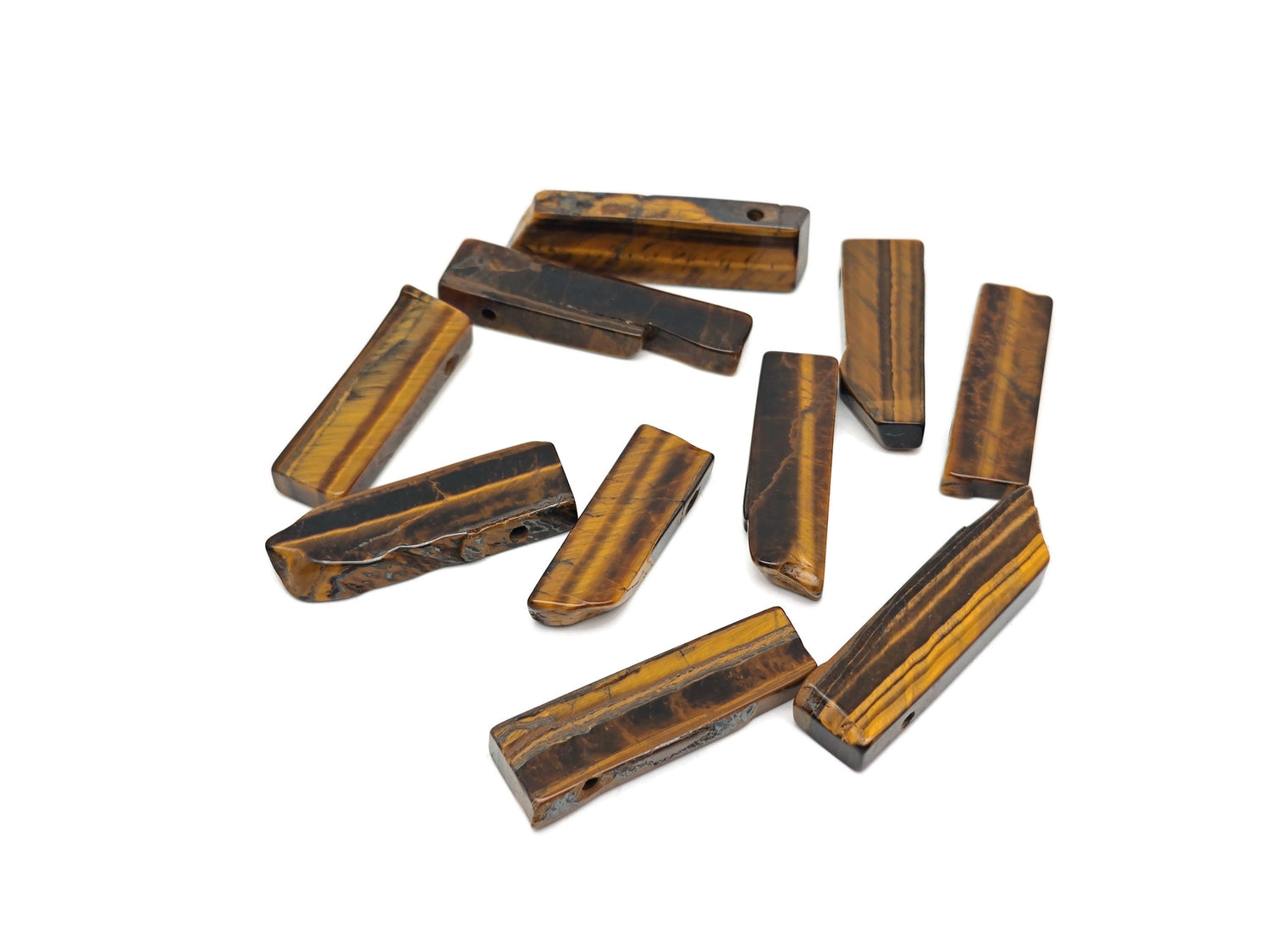 Tiger Eye drilled tumbled gemstone pendant from GemstoneGO, showcasing a smooth, polished oval stone with drilled hole for jewelry.