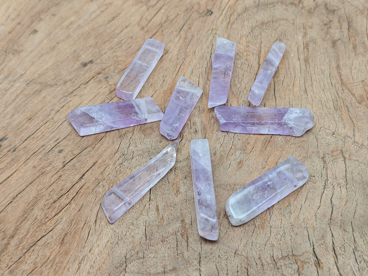 Amethyst drilled tumbled gemstone pendant from GemstoneGO showing a smooth purple amethyst stone with drilled hole for jewelry.