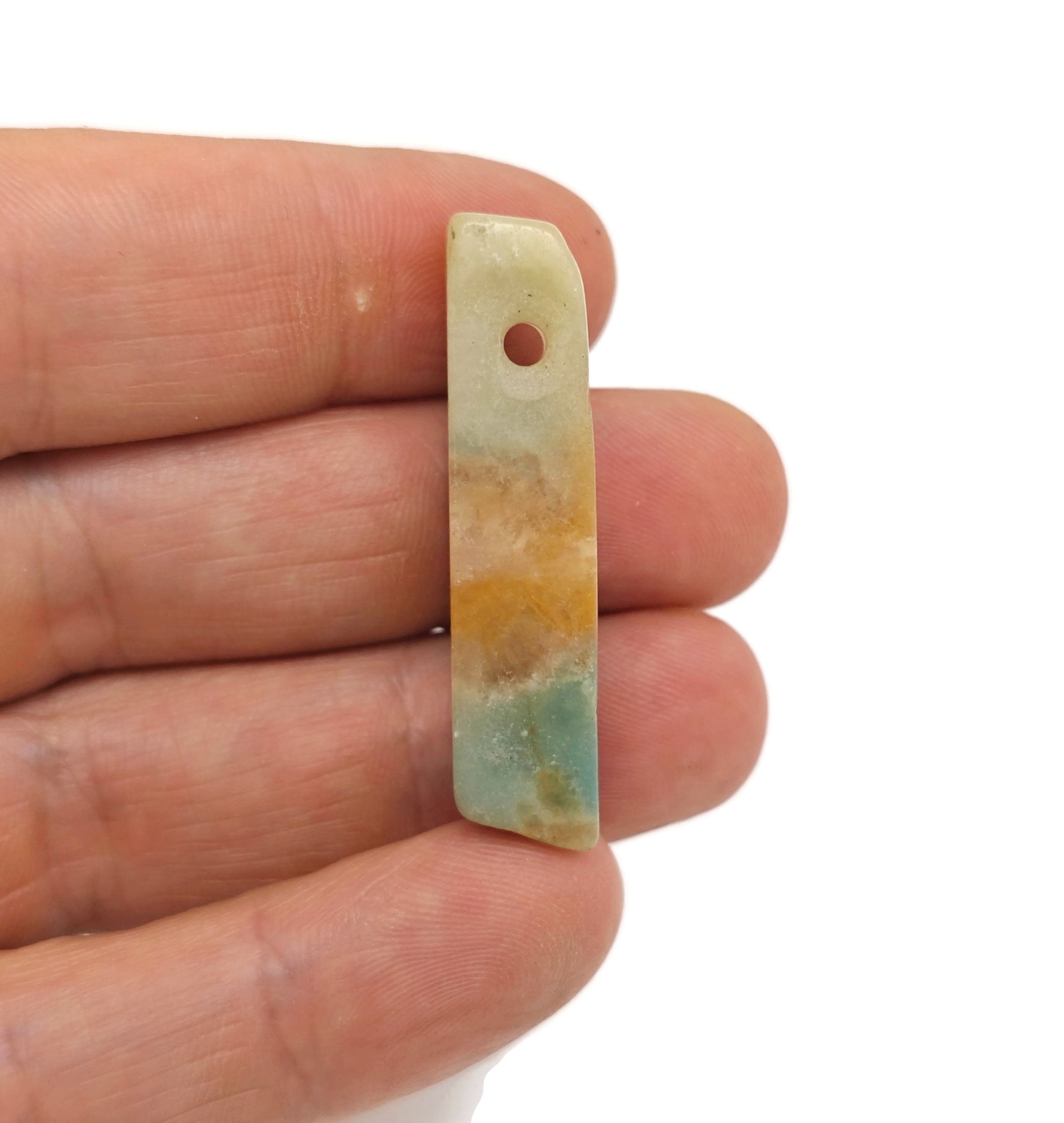 Caribbean calcite drilled tumbled gemstone pendant from GemstoneGO, showcasing vibrant orange and yellow hues with a smooth, polished finish.