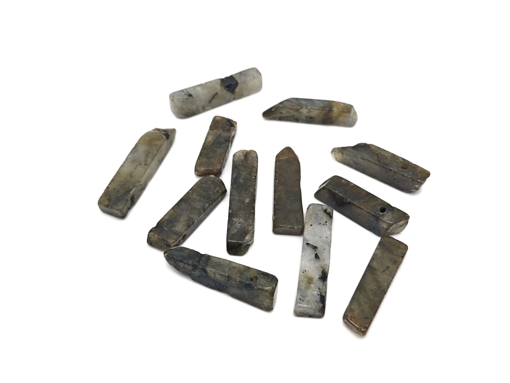 Labradorite drilled tumbled gemstone pendant from GemstoneGO showing iridescent gray-blue labradorite stone with drilled hole for jewelry.
