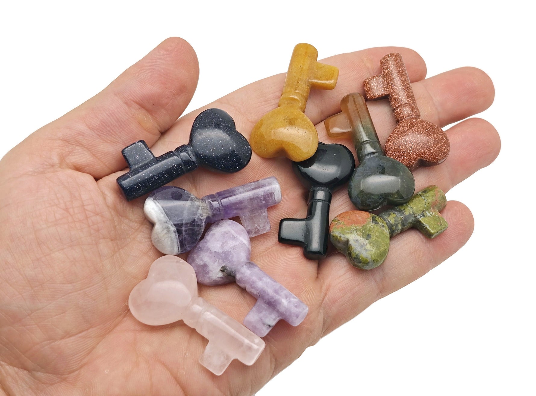 Colorful gemstone carving of a pocket crystal key from GemstoneGO, featuring chakra crystals for meditation and energy healing.