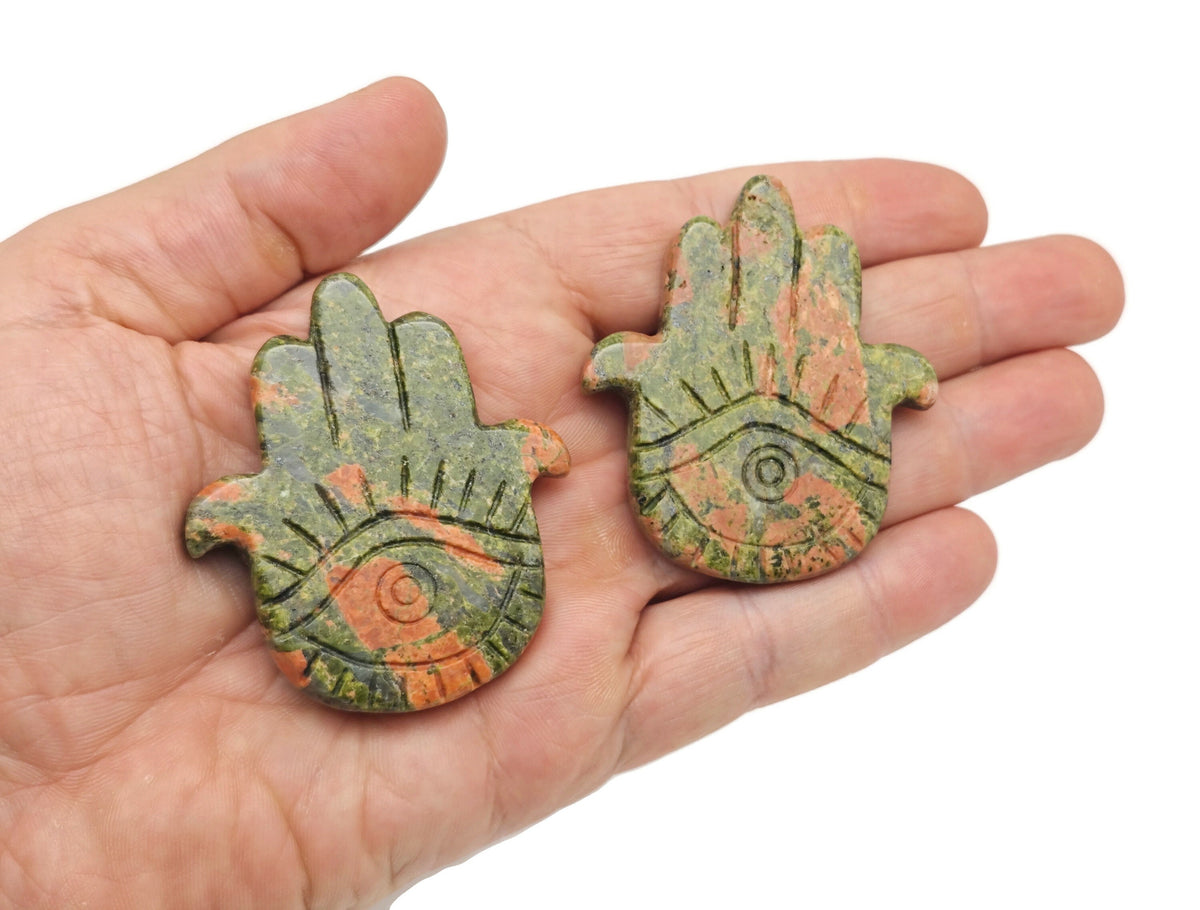 Evil Eye hand gemstone carving pocket crystal with chakra and meditation stones, featuring vibrant gemstone colors and intricate detailing.