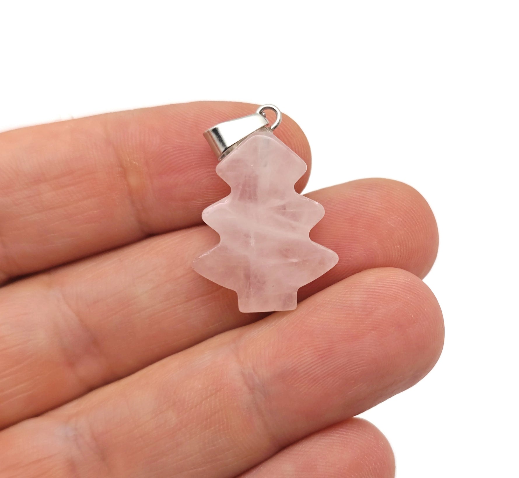 Mini rose quartz gemstone pendant in the shape of a pine tree, featuring a clear crystal and natural pink hue.
