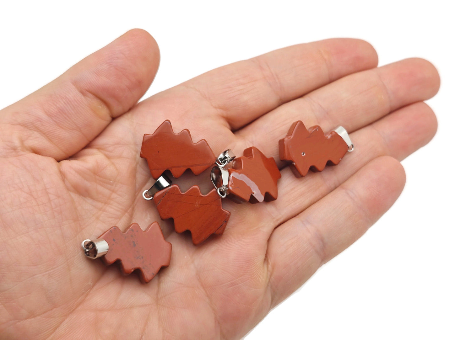 Red Jasper Pine Tree gemstone pendant featuring a mini crystal design, showcasing a detailed red jasper pine tree on a silver setting.