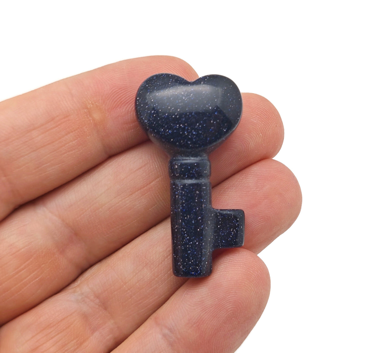Blue Goldstone key gemstone carving, 40mm, from GemstoneGO, showing a detailed carved key with shimmering blue and gold hues.