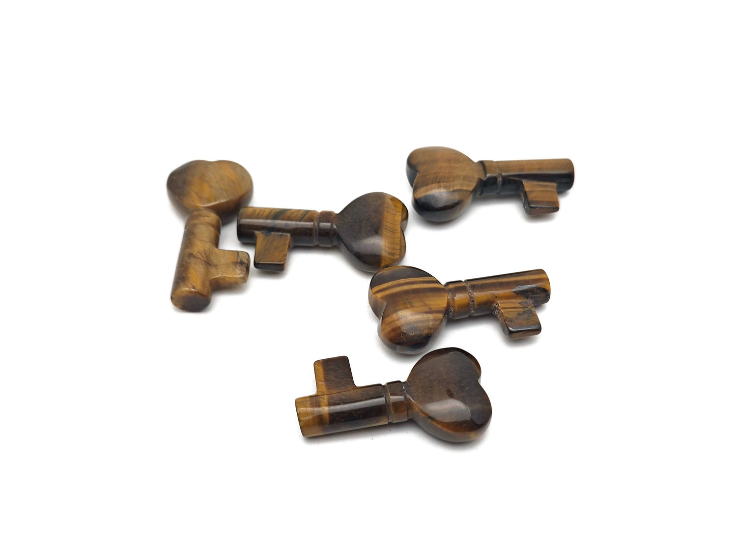 Tiger Eye gemstone key carving, 40mm, from GemstoneGO, showing a polished, detailed tiger eye stone with a metal key ring attachment.