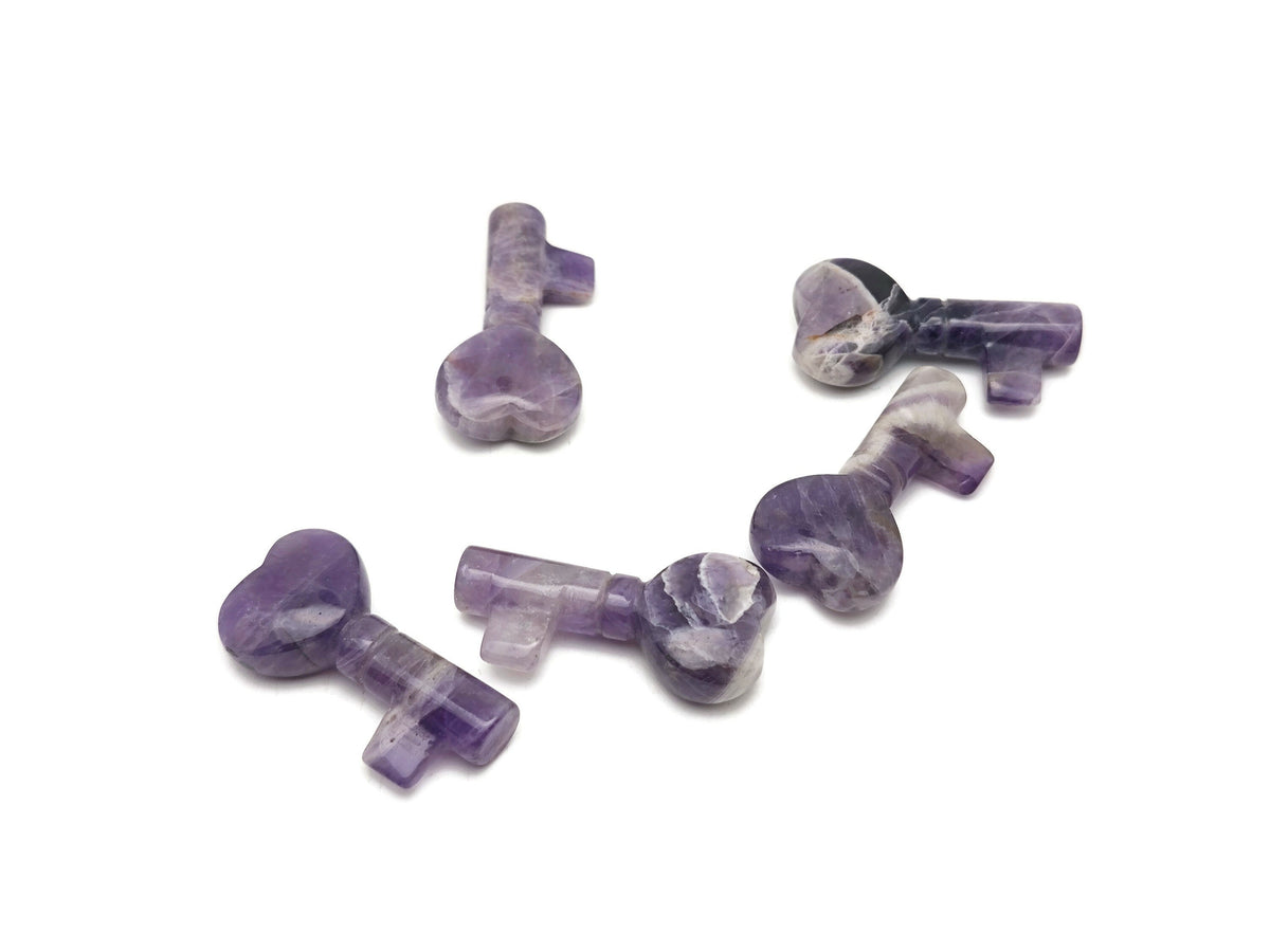 Amethyst gemstone key carving, 40mm, crafted by GemstoneGO, featuring detailed purple amethyst stone with carved key design.