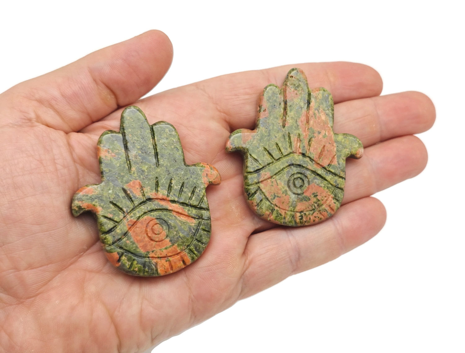 Unakite evil eye hand gemstone carving from GemstoneGO, detailed view of the carved protective talisman.