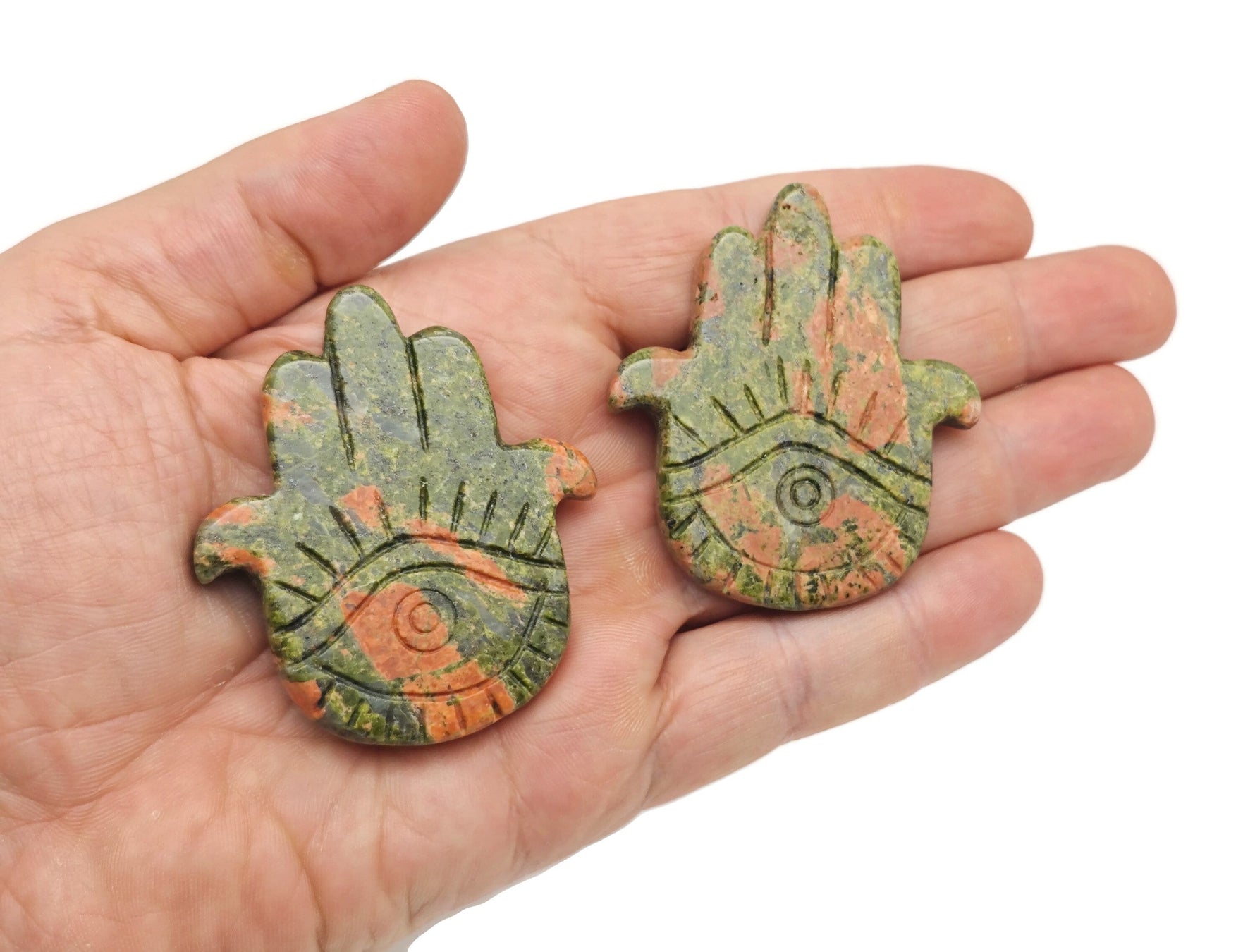 Unakite evil eye hand gemstone carving from GemstoneGO, detailed view of the carved protective talisman.