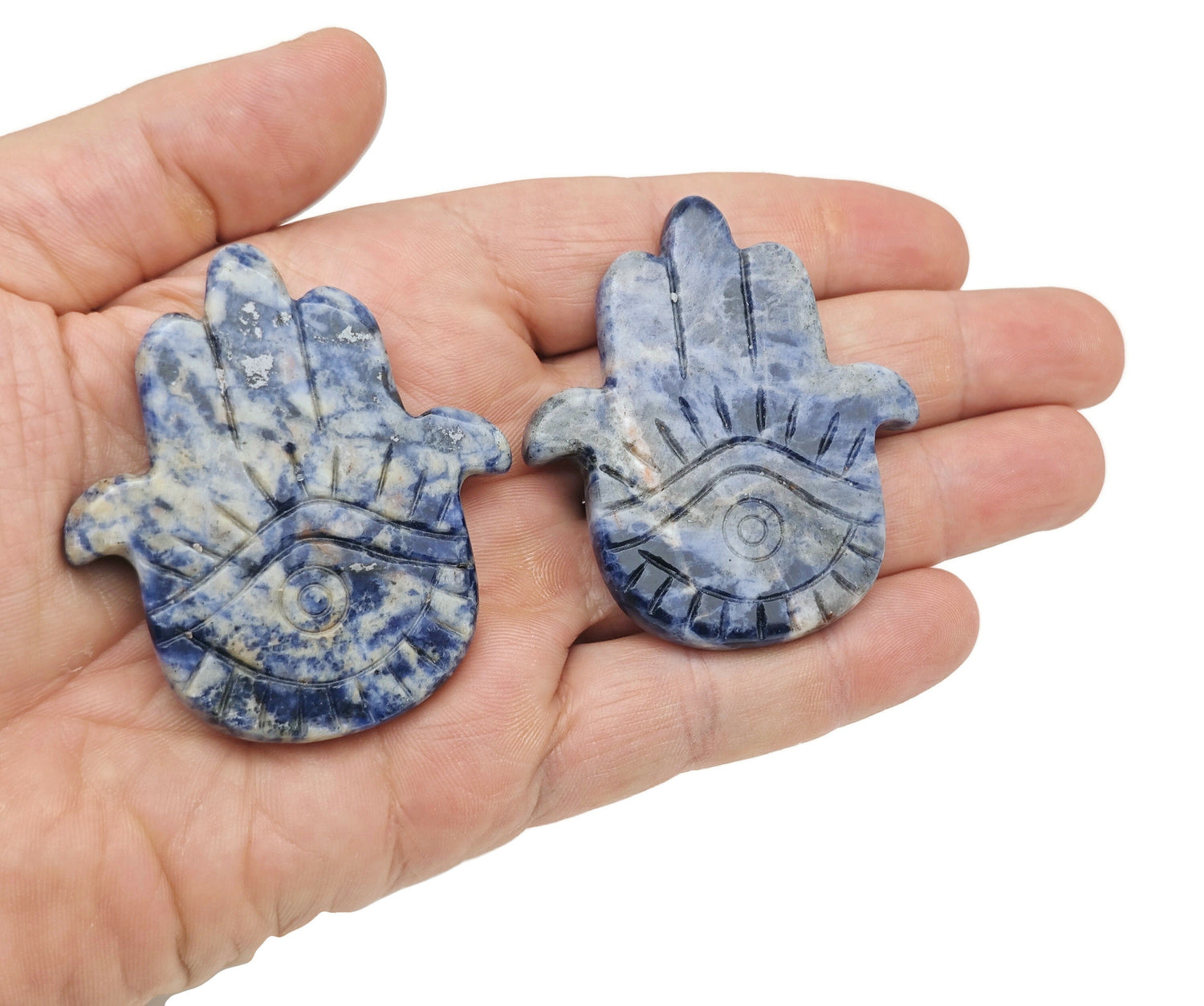Sodalite evil eye hand gemstone carving with intricate details, crafted by GemstoneGO, showcasing vibrant blue and white stone patterns.