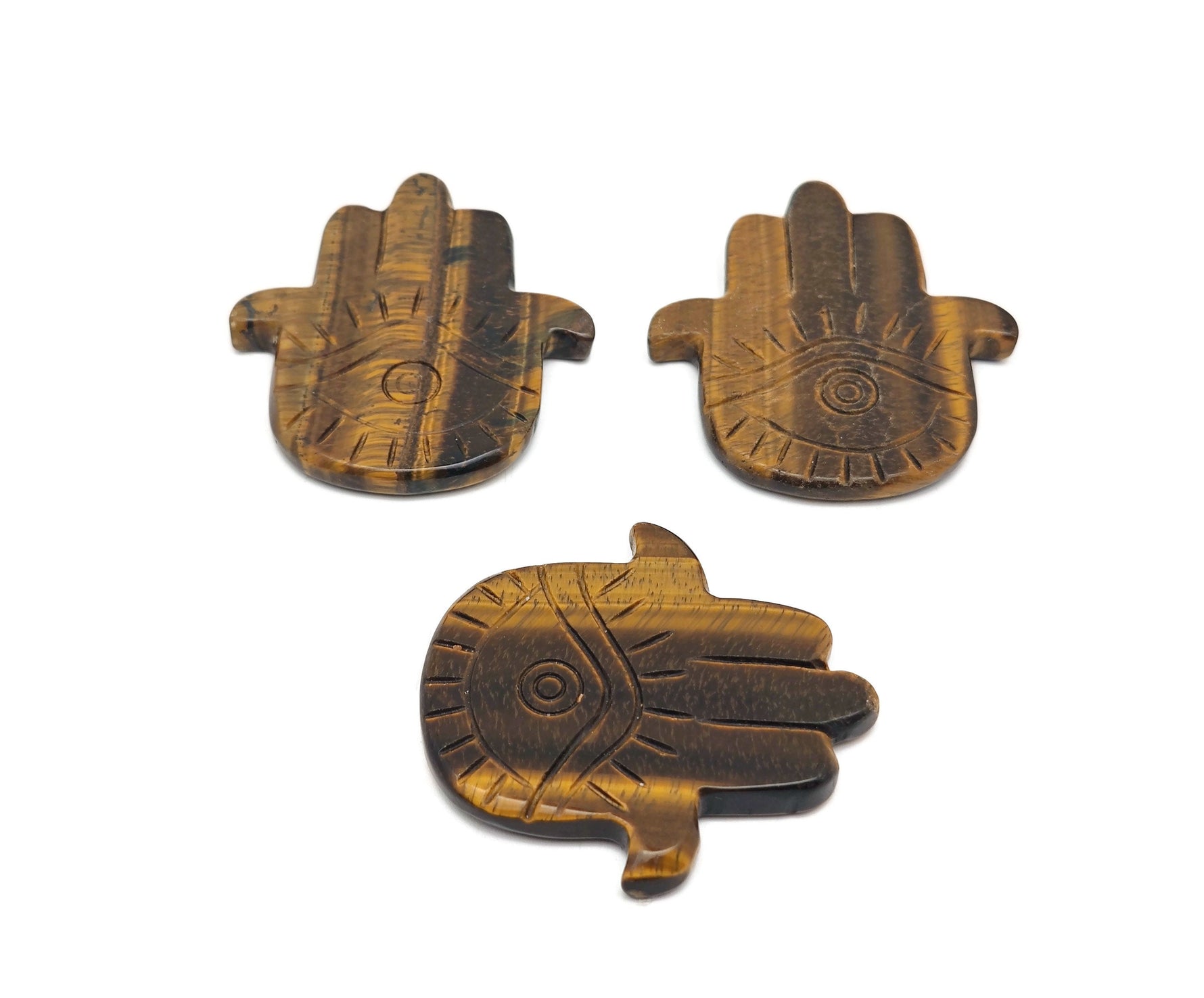 Tiger Eye Evil Eye hand-carved gemstone pendant showing detailed carving and vibrant colors, crafted by GemstoneGO.