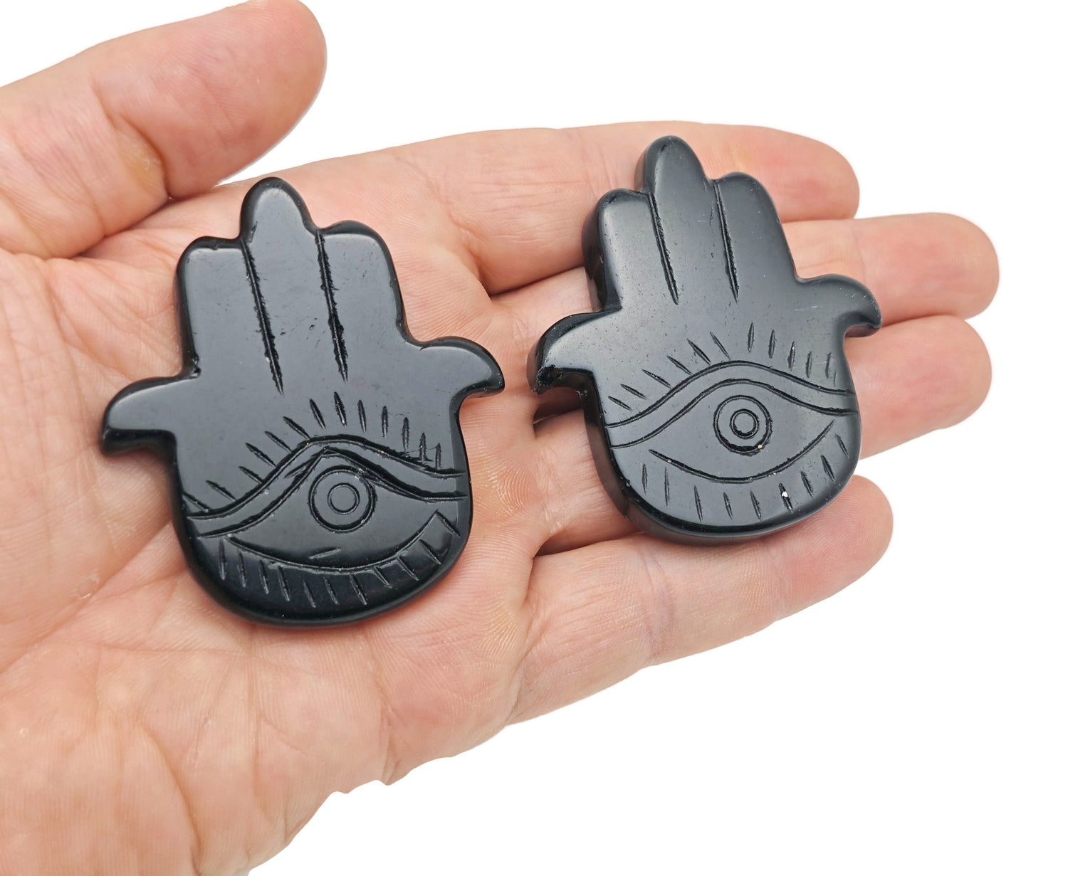 Obsidian evil eye hand gemstone carving with intricate details, crafted by GemstoneGO, showcasing protective mystical design.