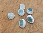 A polished aventurine seer tumbled river stone from GemstoneGO, showcasing smooth green gemstone with natural patterns and shine.