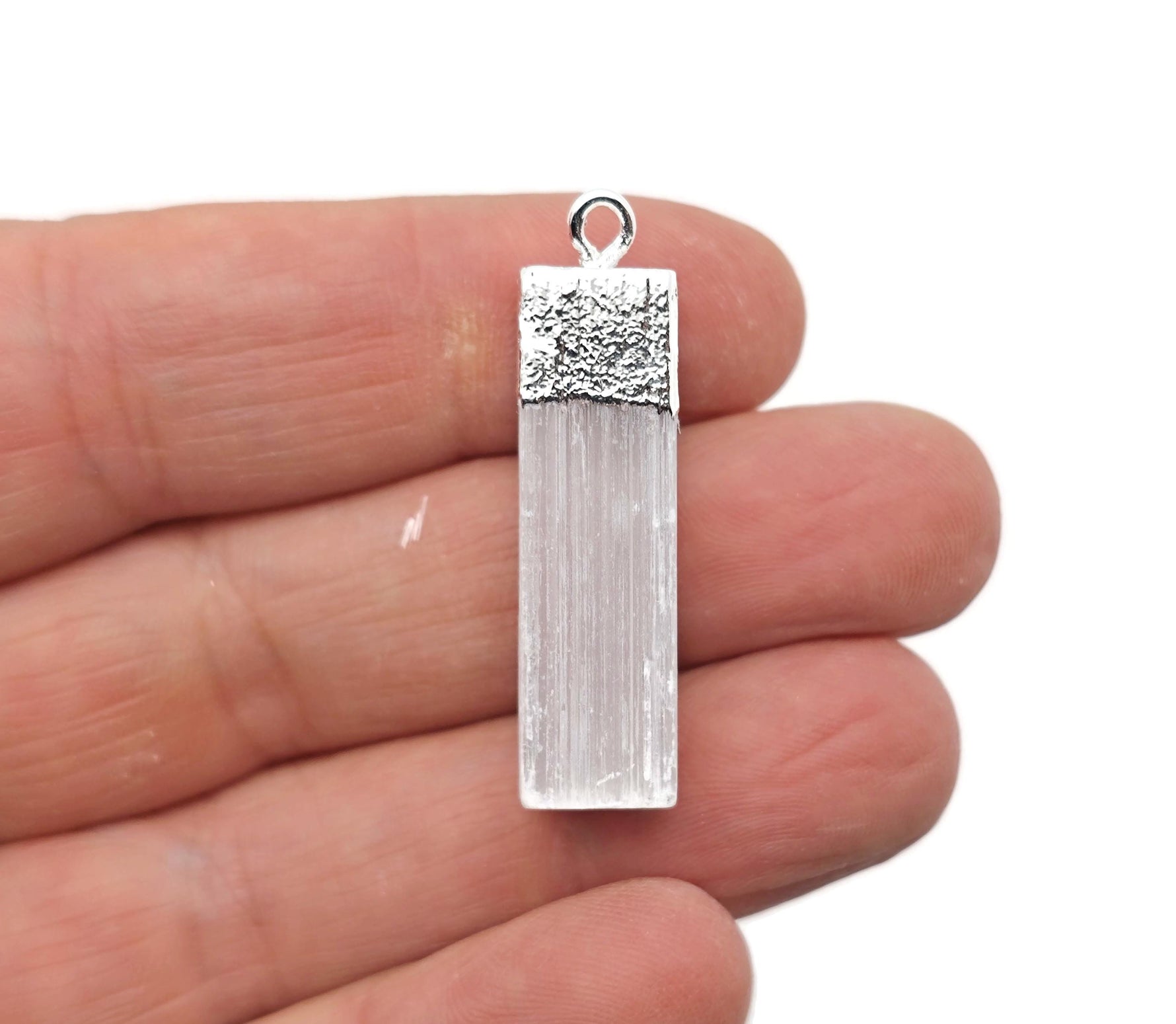 Selenite stick pendant from GemstoneGO featuring a clear, healing crystal pendant with a cord for necklace wear.