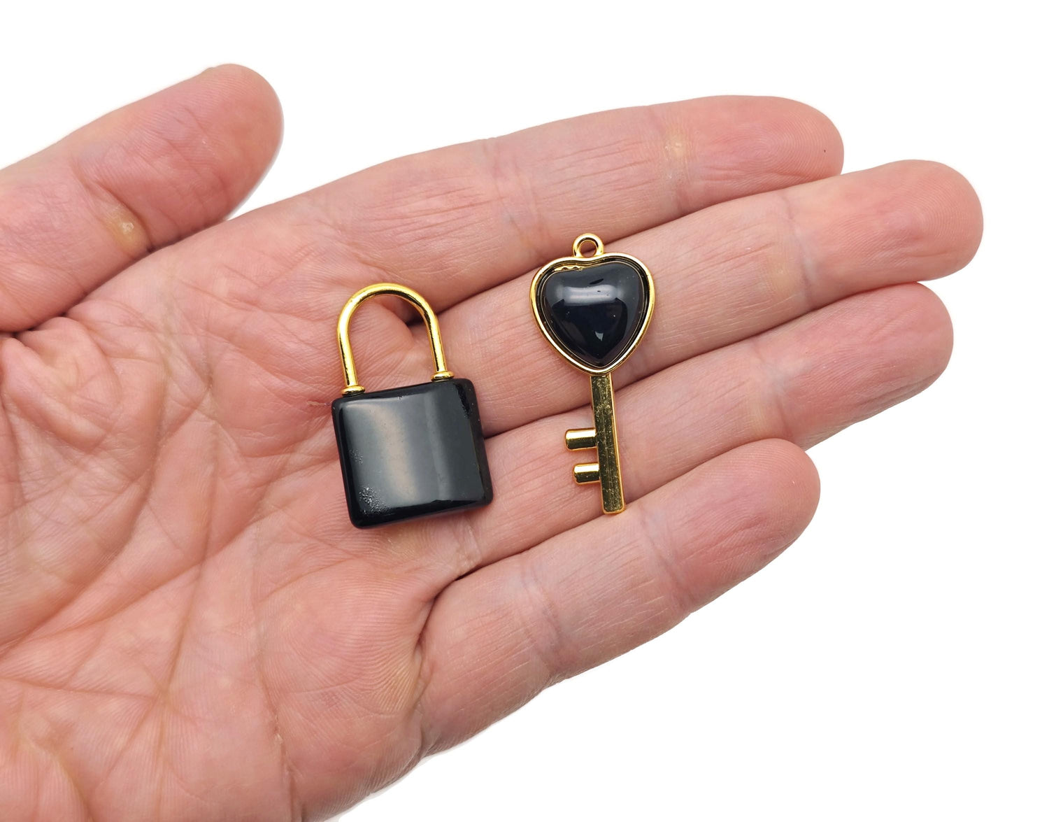 Obsidian heart-shaped crystal pendant with a silver bail, showcasing a polished black gemstone with natural faceting.