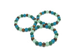 Handmade gemstone intention bracelet with colorful beads and a silver charm, designed for positive energy and style.