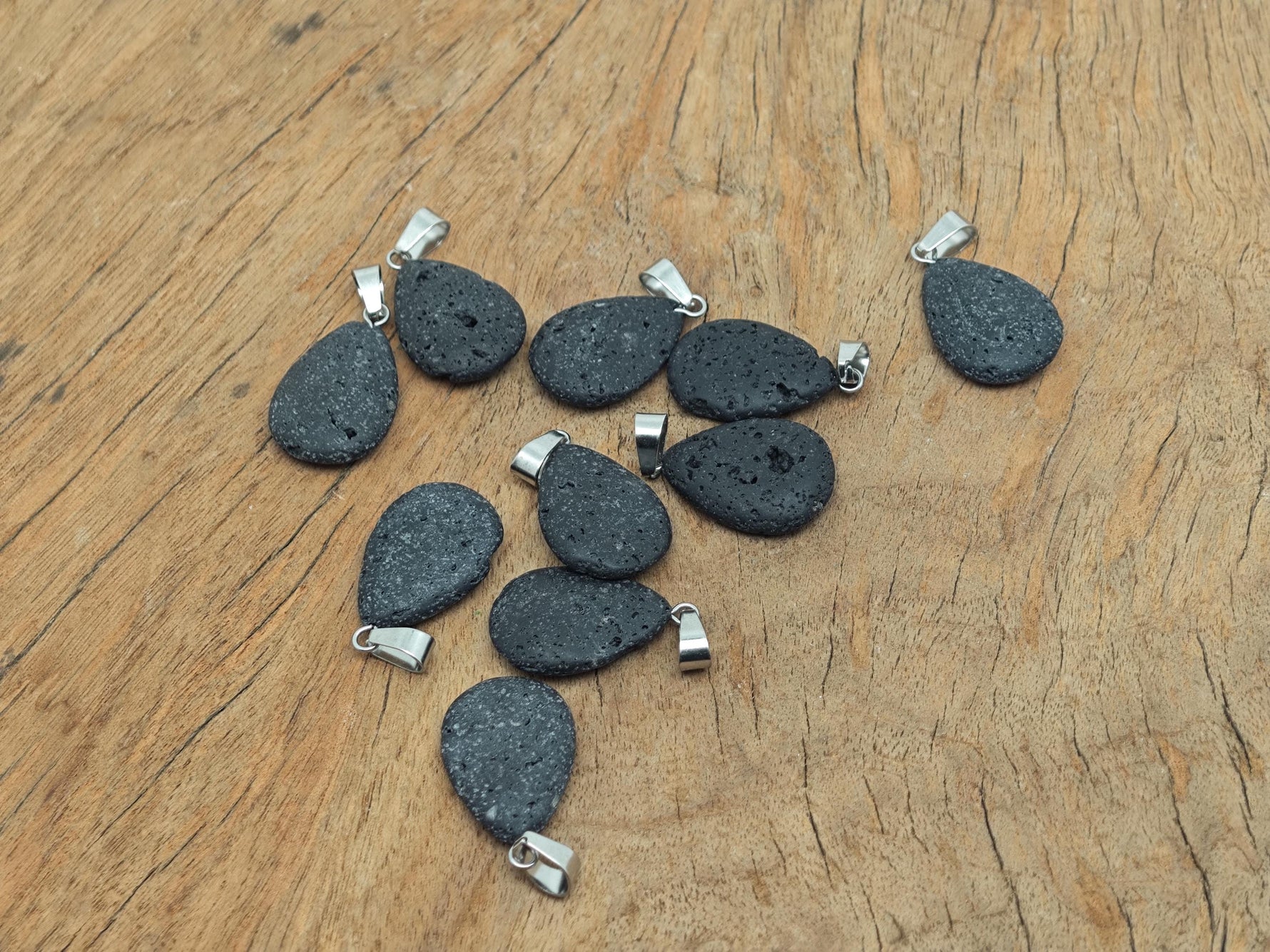 Lava crystal pendant featuring a spiritual stone design from GemstoneGO, showcasing a black volcanic rock pendant with intricate carvings.
