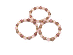 Handmade empowerment gemstone bracelet with colorful beads and a central charm, designed for intention and positive energy.