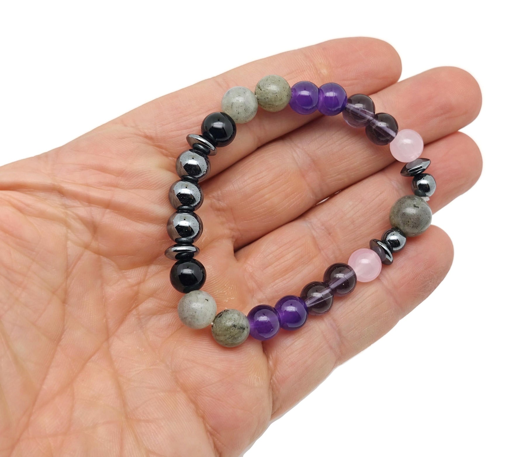 Handmade Triple Prosperity gemstone bracelet with colorful beads and silver accents, designed for positive intentions.
