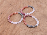 Handmade self-love gemstone bracelet with colorful beads and a silver clasp, designed for positive intentions and personal empowerment.