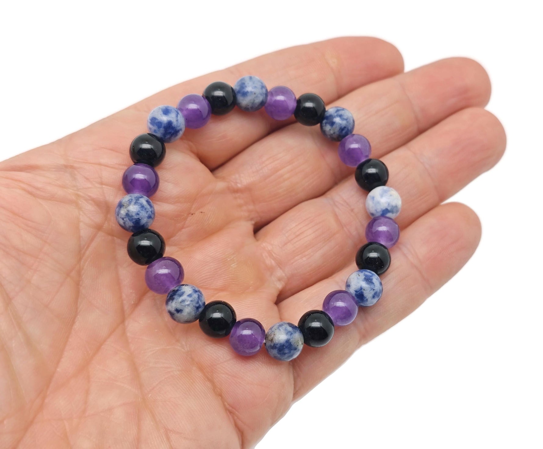 Handmade gemstone bracelet with smooth, colorful stones on elastic cord, designed for intention and soothing energy by GemstoneGO.