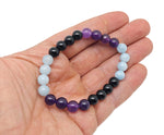 Handmade gemstone pain relief bracelet with colorful beads and adjustable cord, designed for intention and wellness.
