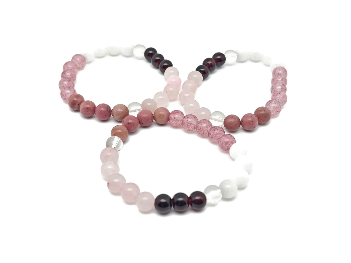 Handmade Love and Attract gemstone bracelet featuring colorful beads and a silver charm, designed for positive intentions.