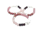 Handmade Love and Attract gemstone bracelet featuring colorful beads and a silver charm, designed for positive intentions.