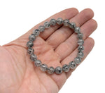 Tourmalinated Quartz beaded crystal bracelet for men and women, featuring black and clear gemstone beads on a stretchy band.
