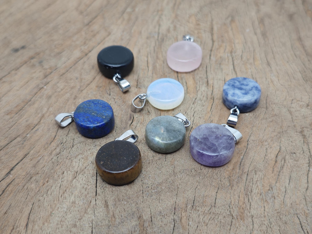 Round gemstone pendant featuring a clear crystal coin cabochon, loose gemstone from GemstoneGO with a flat, polished surface.