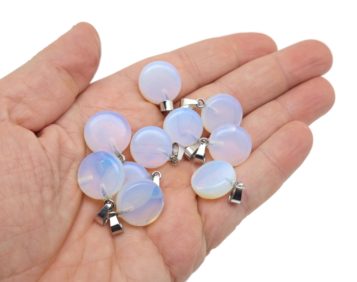 Opalite flat round gemstone pendant with a crystal round coin design, featuring smooth, polished surface and silver bail attachment.