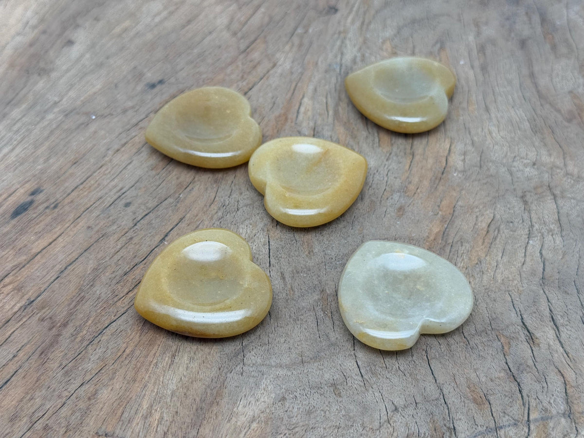 Yellow jade heart worry stone from GemstoneGO, smooth soothing crystal with polished surface, used for calming and stress relief.