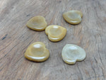 Yellow jade heart worry stone from GemstoneGO, smooth soothing crystal with polished surface, used for calming and stress relief.