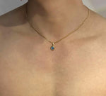Gold mini evil eye pendant with silver Nazar eye design, gemstoneGO jewelry, showcasing the detailed evil eye charm.