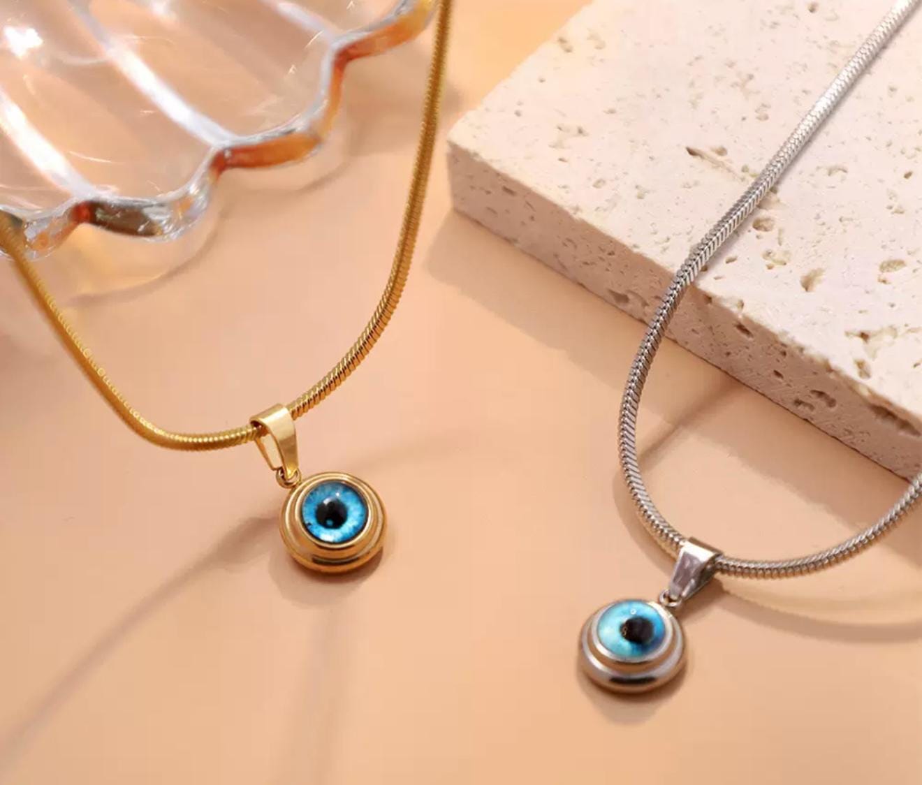 Gold and silver mini evil eye pendant with Nazar design, featuring a protective evil eye charm from GemstoneGO.