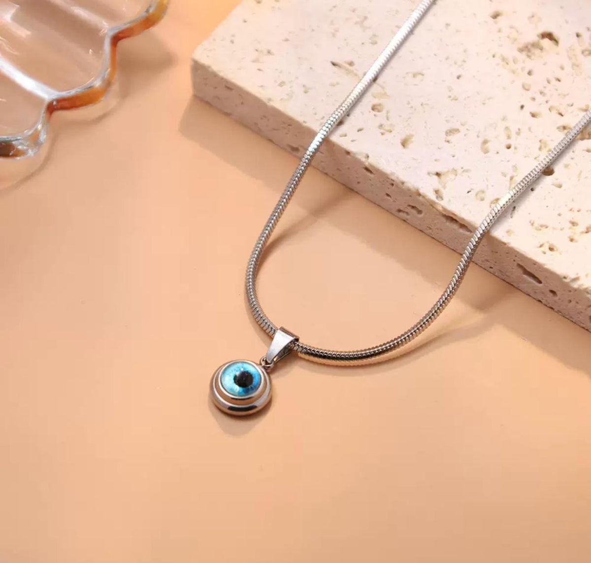 Gold and silver mini evil eye pendant with Nazar design, featuring a protective evil eye charm from GemstoneGO.