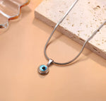 Gold and silver mini evil eye pendant with Nazar design, featuring a protective evil eye charm from GemstoneGO.