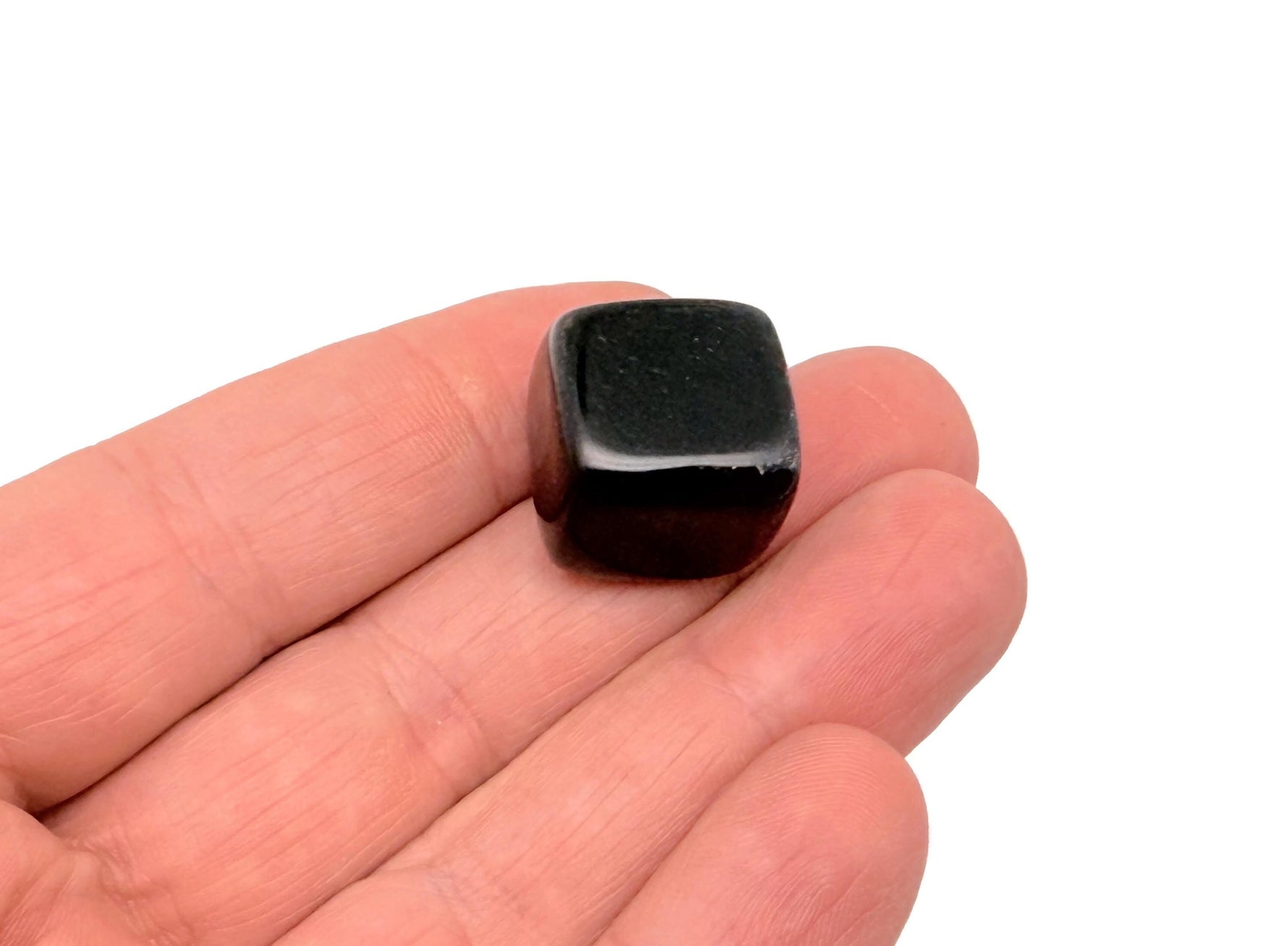 Handmade 16mm obsidian cube stone with carved design from GemstoneGO, showcasing its glossy black surface and detailed craftsmanship.