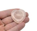 Rose quartz heart worry stone from GemstoneGO, a soothing crystal for stress relief and emotional healing, shown in close-up.
