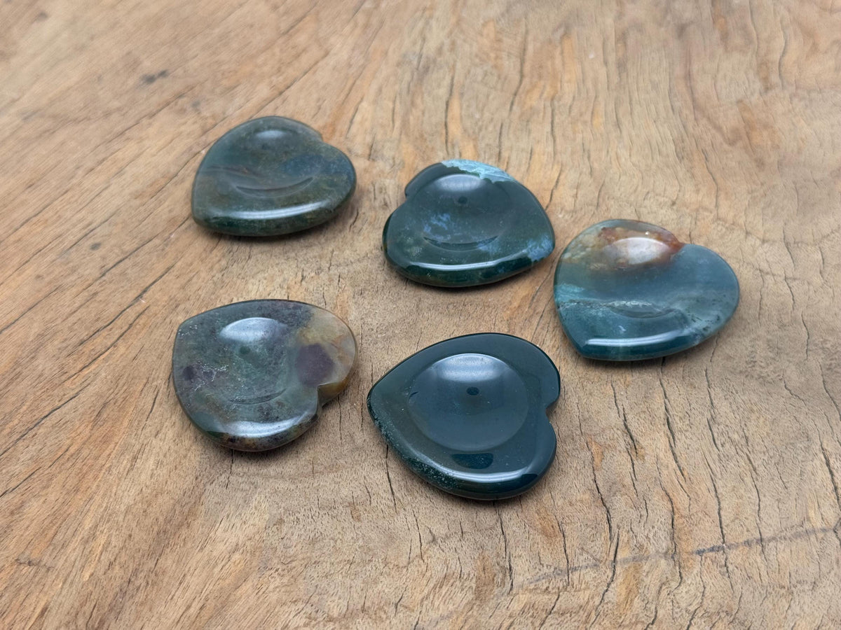Moss agate heart worry stone from GemstoneGO, a soothing crystal with intricate green and brown moss patterns on smooth polished surface.