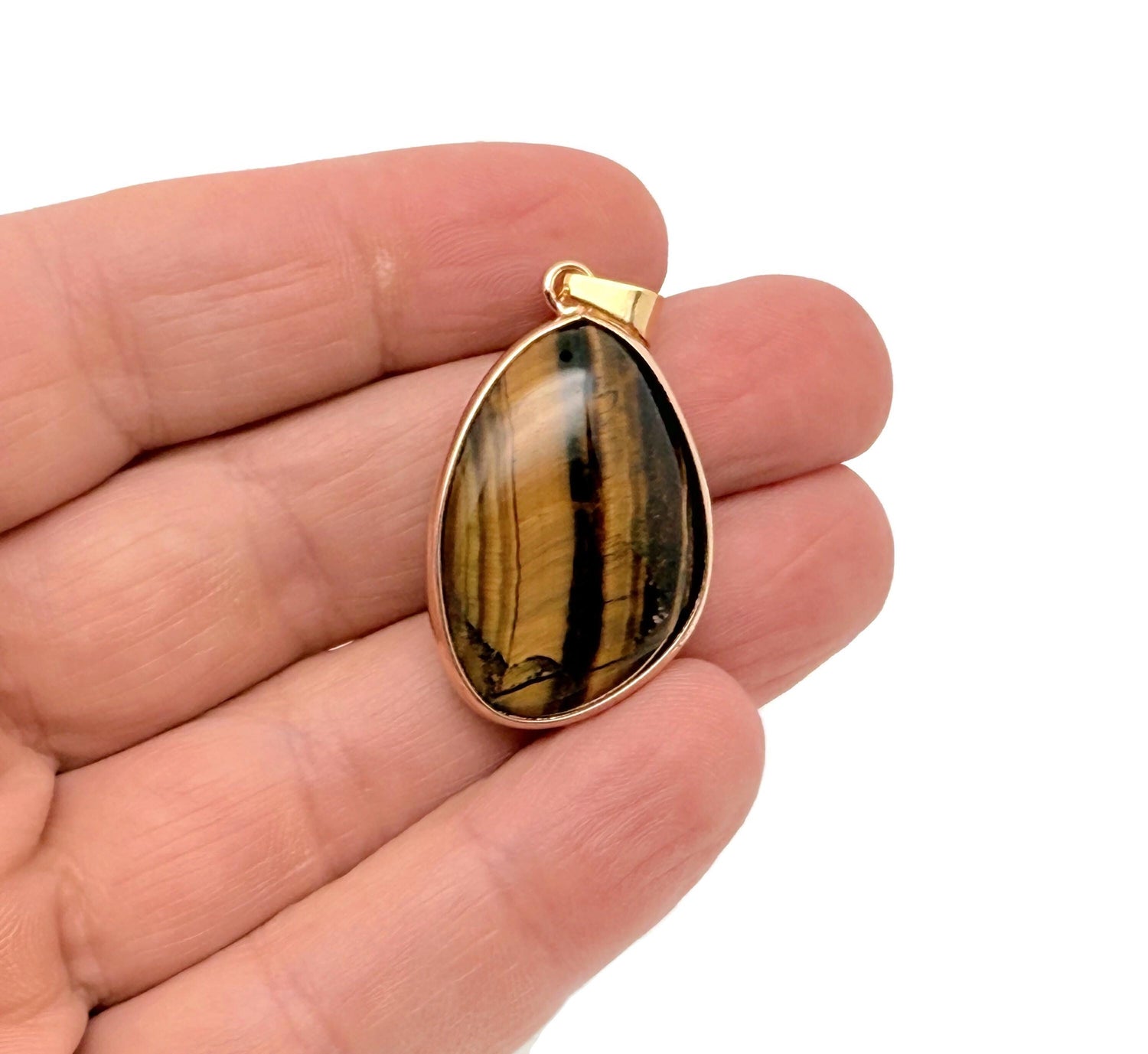 Dainty Tiger Eye gold gemstone pendant with polished oval stone and gold bail, ideal for DIY jewelry making by GemstoneGO.