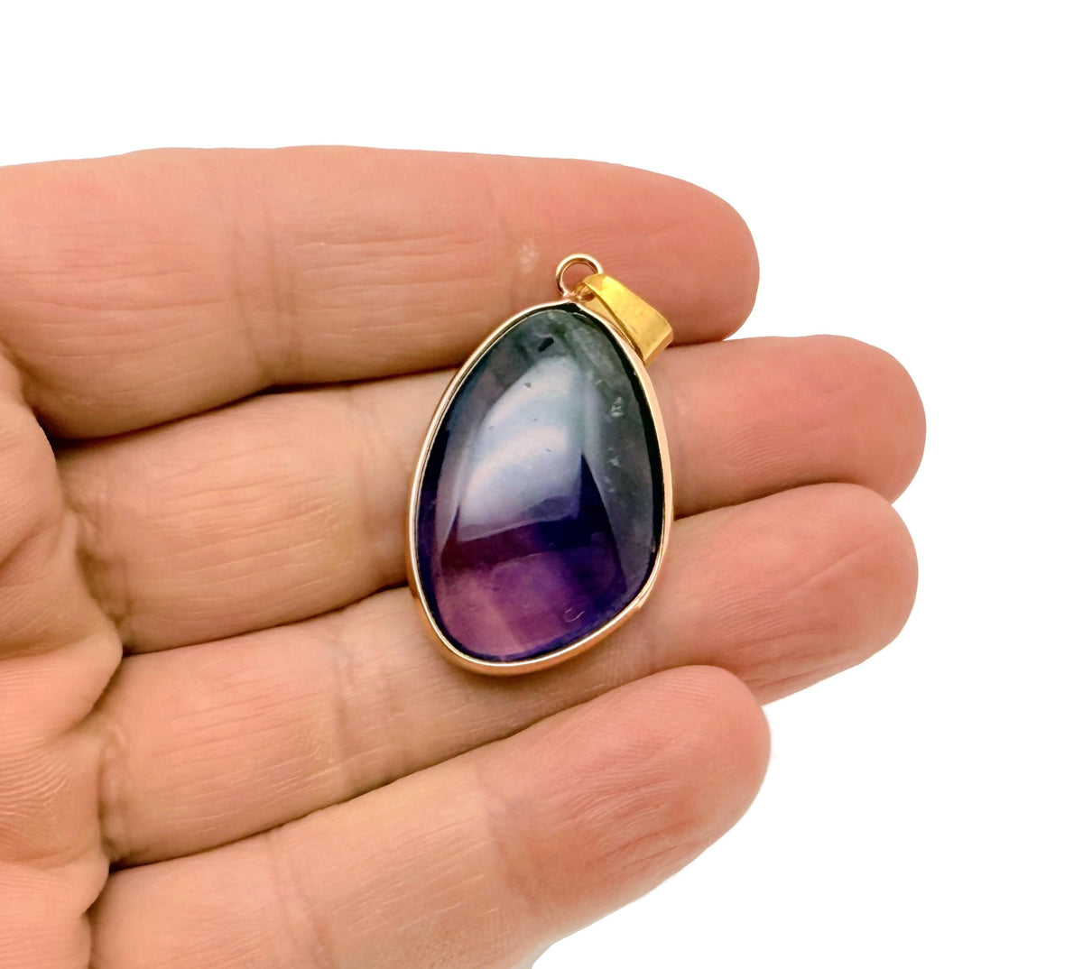 Dainty fluorite gold gemstone pendant with a silver chain, featuring a vibrant purple and green polished stone for jewelry making.