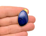 Dainty Lapis Lazuli gold gemstone pendant with a gold chain, featuring a vibrant blue stone and intricate gold detailing.